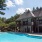a clubhouse with a pool in the front