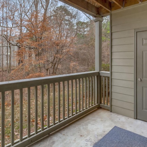 a porch with a fence and a door