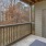 a porch with a fence and a door