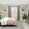 a bedroom with a bed and a plant